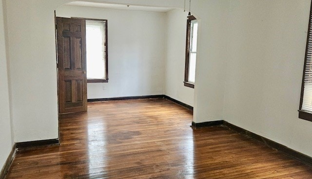 unfurnished room with dark hardwood / wood-style floors