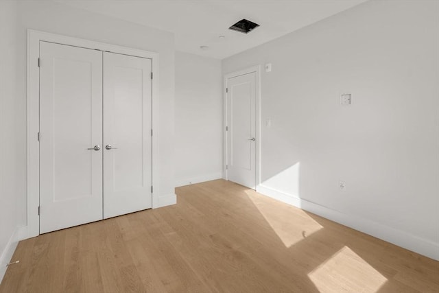 301 Border Unit U606, Boston, MA 02128 - unfurnished bedroom featuring baseboards, light wood-style floors, and a closet