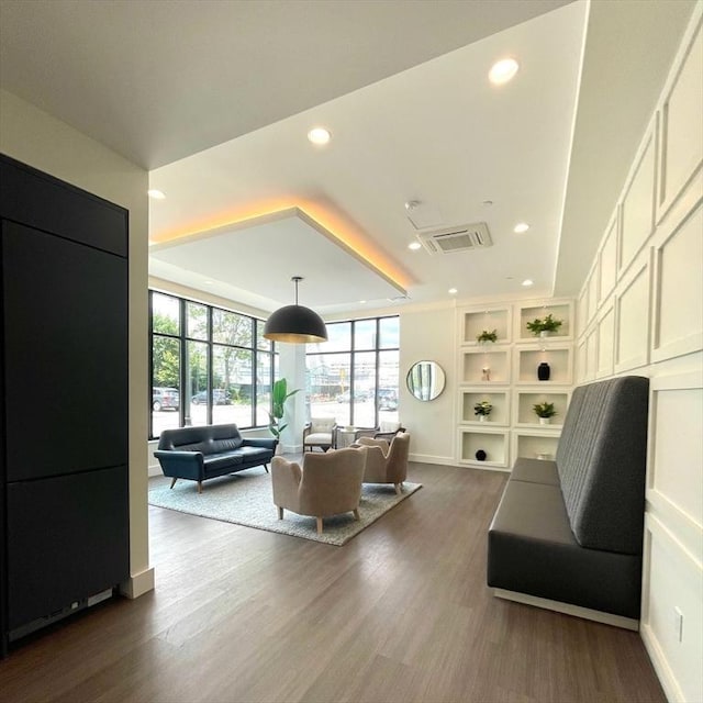 301 Border Unit U606, Boston, MA 02128 - living room featuring recessed lighting, dark wood-type flooring, a wall of windows, built in shelves, and baseboards