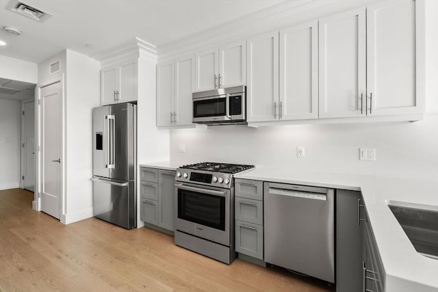 301 Border Unit U606, Boston, MA 02128 - kitchen featuring appliances with stainless steel finishes, gray cabinetry, light countertops, and light wood-style flooring