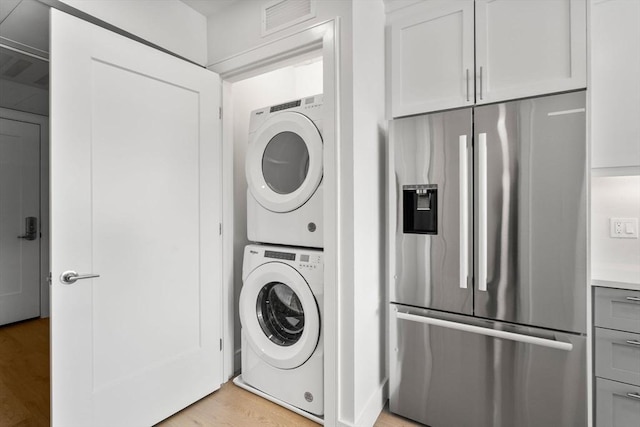 301 Border Unit U606, Boston, MA 02128 - washroom featuring stacked washer and clothes dryer and light wood finished floors