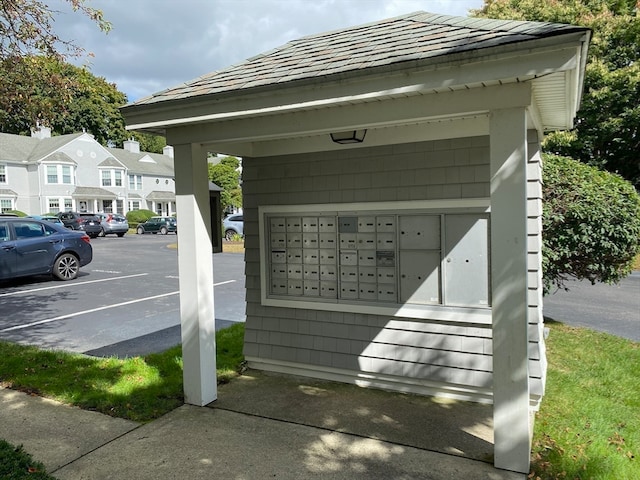 view of vehicle parking featuring a mail area