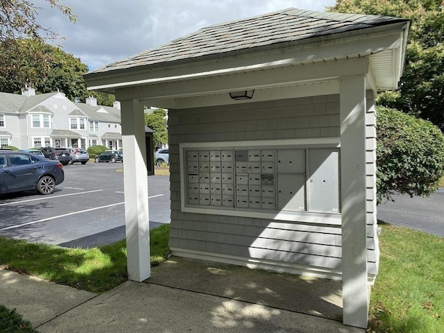 surrounding community featuring mail area, a residential view, and uncovered parking