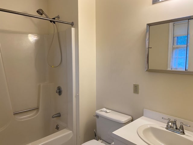 bathroom with shower / bath combination, vanity, and toilet