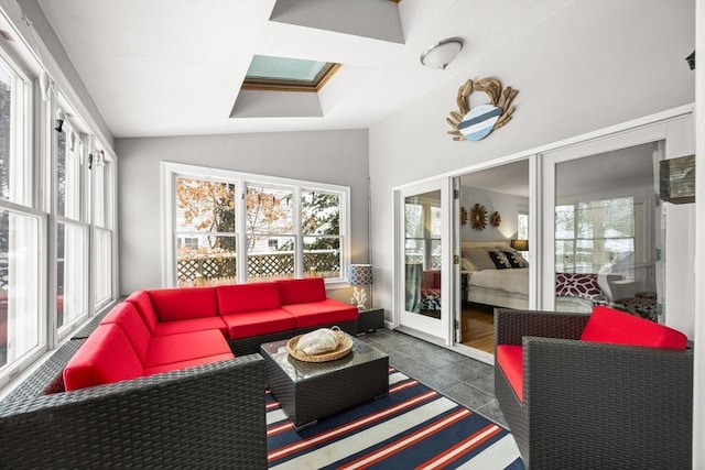 sunroom with lofted ceiling with skylight and a healthy amount of sunlight