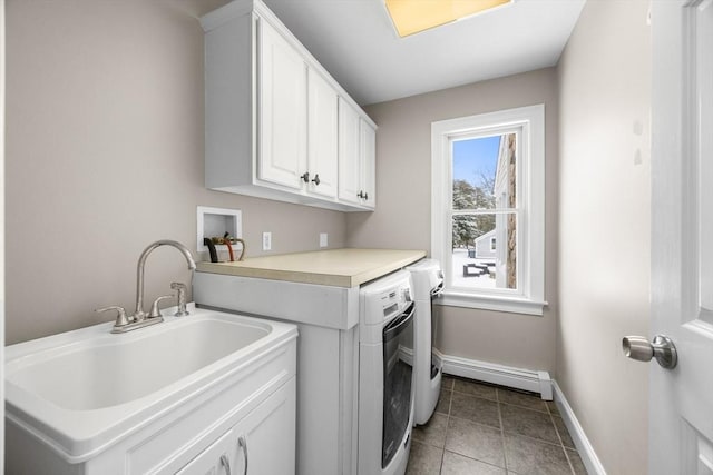 laundry room featuring washer and dryer, a baseboard heating unit, a sink, cabinet space, and baseboards