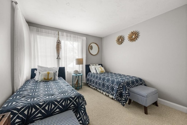 carpeted bedroom with baseboards