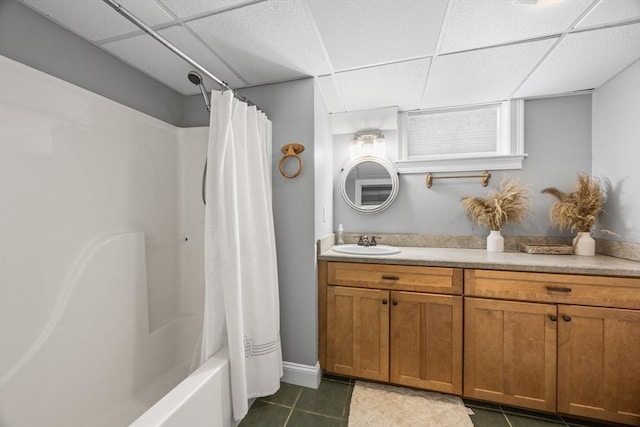 bathroom featuring vanity, tile patterned floors, shower / bathtub combination with curtain, and a paneled ceiling