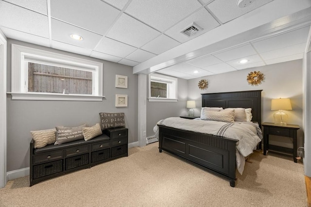 carpeted bedroom with visible vents, a baseboard heating unit, baseboards, a drop ceiling, and recessed lighting