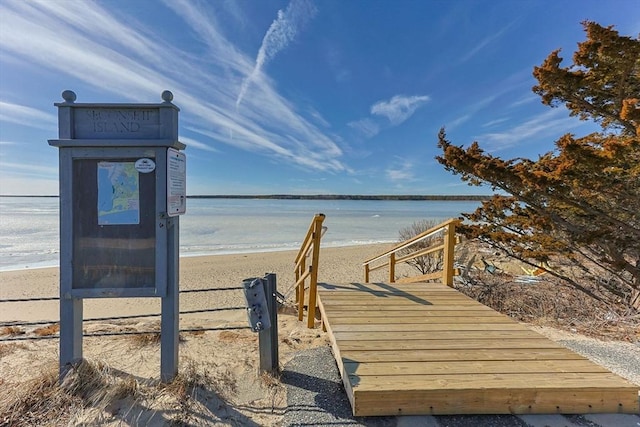 surrounding community featuring a view of the beach and a water view