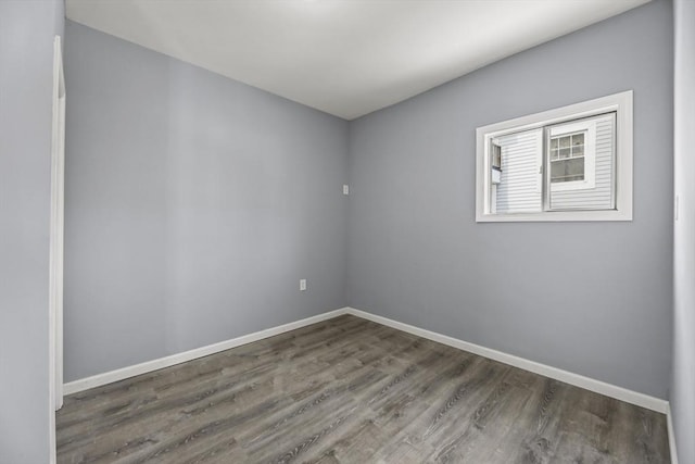 spare room featuring dark wood-type flooring