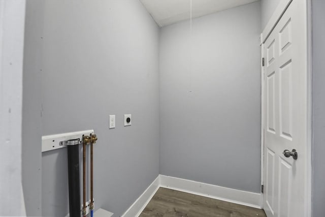 washroom with dark hardwood / wood-style flooring and electric dryer hookup