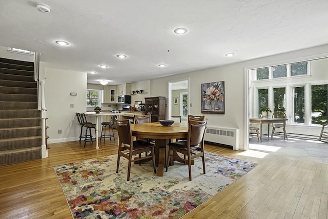37 Eastview Rd, Hopkinton, MA 01748 - dining room featuring radiator heating unit, light wood-style floors, stairway, recessed lighting, and baseboards