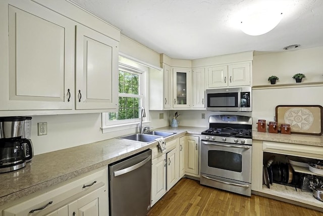 37 Eastview Rd, Hopkinton, MA 01748 - kitchen with stainless steel appliances, a sink, light countertops, and wood finished floors