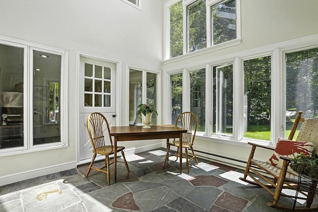 37 Eastview Rd, Hopkinton, MA 01748 - sunroom with plenty of natural light, stone finish floors, a towering ceiling, and baseboards