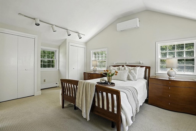 37 Eastview Rd, Hopkinton, MA 01748 - bedroom featuring an AC wall unit, baseboard heating, track lighting, vaulted ceiling, and two closets