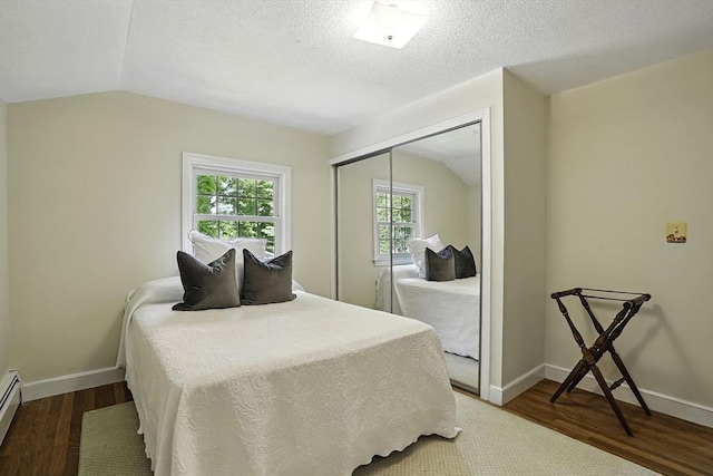 37 Eastview Rd, Hopkinton, MA 01748 - bedroom featuring wood finished floors, vaulted ceiling, a closet, baseboard heating, and baseboards