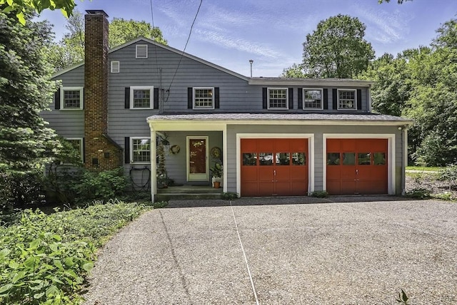 37 Eastview Rd, Hopkinton, MA 01748 - view of front of home featuring a chimney, driveway, and a garage