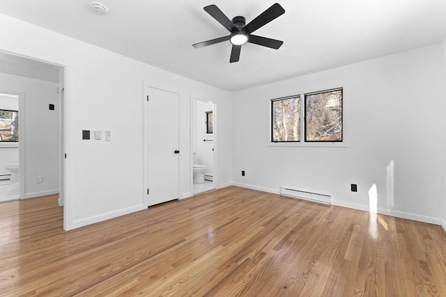 unfurnished room featuring ceiling fan, light hardwood / wood-style floors, and a baseboard heating unit