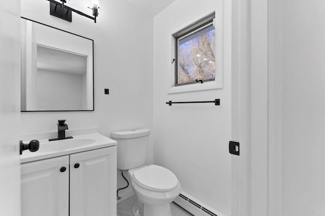 bathroom with vanity, toilet, and a baseboard heating unit