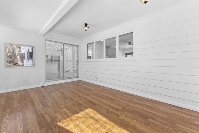 interior space with hardwood / wood-style flooring, crown molding, and an inviting chandelier