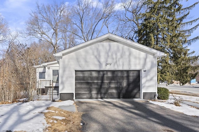 snow covered property with a garage