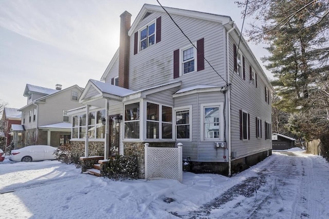 view of front of house featuring a sunroom