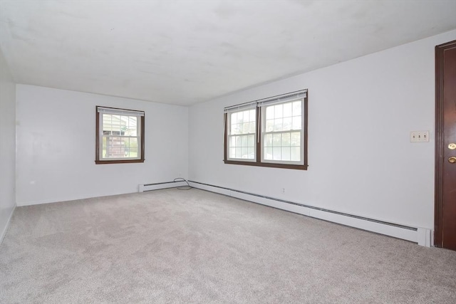 empty room featuring carpet flooring and a baseboard heating unit