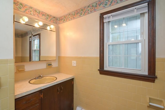 bathroom with vanity, tile walls, and wainscoting