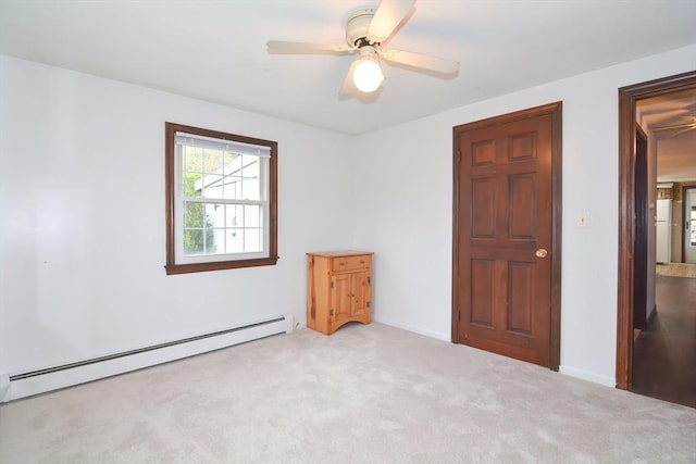 unfurnished bedroom featuring carpet floors, a ceiling fan, and a baseboard heating unit