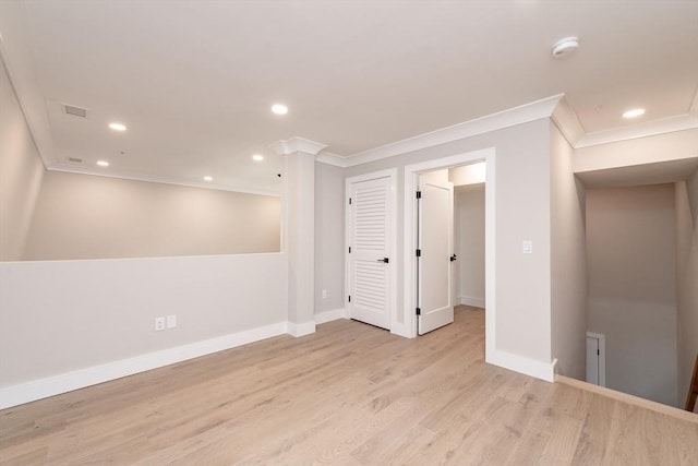 empty room featuring light hardwood / wood-style flooring and ornamental molding