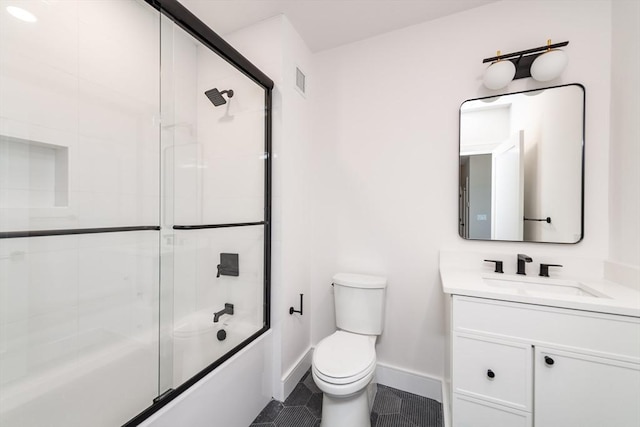 full bathroom featuring vanity, toilet, tile patterned flooring, and combined bath / shower with glass door