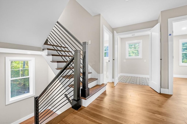 entrance foyer featuring a healthy amount of sunlight, stairway, and light wood-style floors