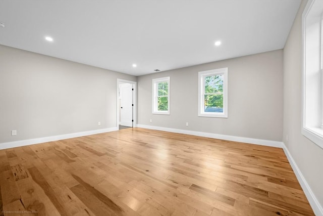 empty room with recessed lighting, baseboards, and light wood-style flooring