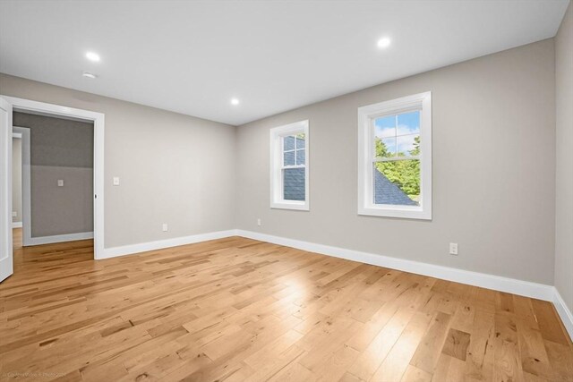 empty room with recessed lighting, baseboards, and light wood-style flooring