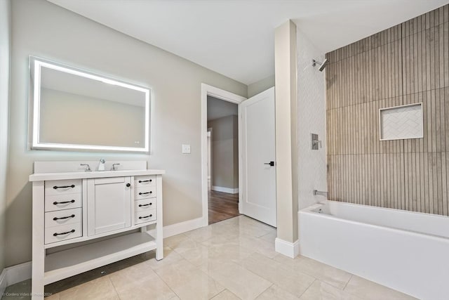 bathroom featuring washtub / shower combination, baseboards, and vanity