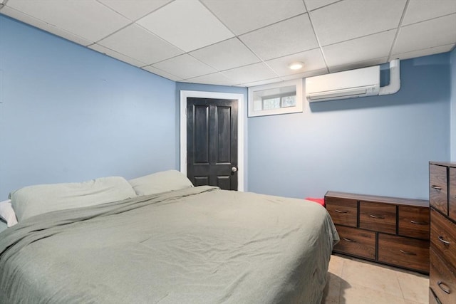 2 Britlees Way, Dudley, MA 01571 - bedroom featuring a wall unit AC, light tile patterned flooring, and a paneled ceiling