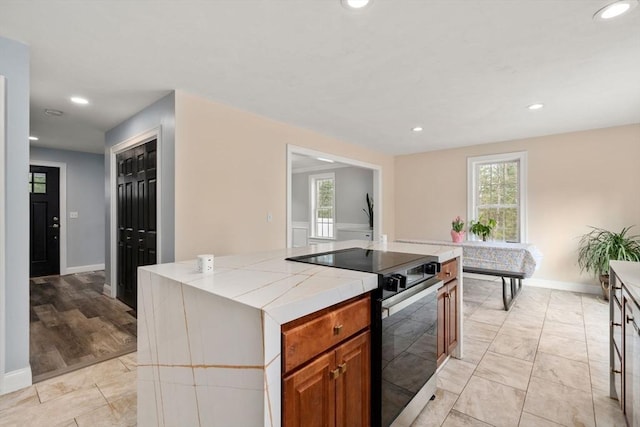 2 Britlees Way, Dudley, MA 01571 - kitchen featuring black electric range, tile counters, plenty of natural light, brown cabinets, and recessed lighting