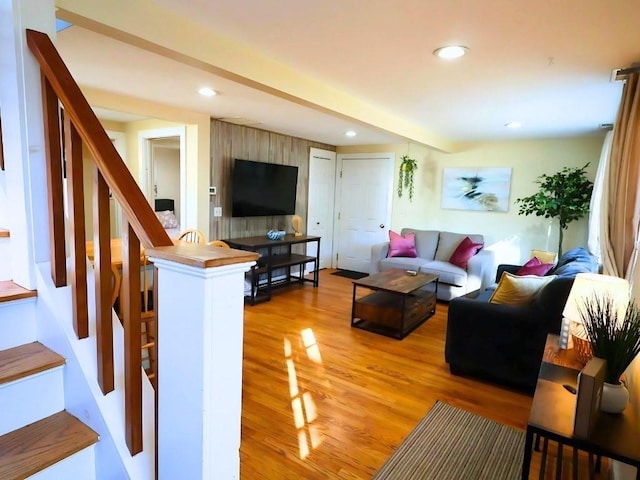 living area featuring light wood-style floors, recessed lighting, and stairs