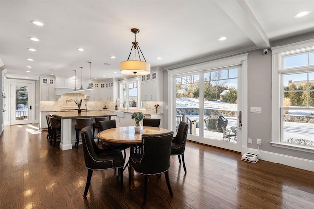 dining area featuring recessed lighting, dark wood-type flooring, baseboards, beamed ceiling, and crown molding