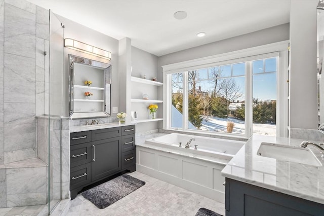 full bath with a garden tub, two vanities, a sink, and a shower stall