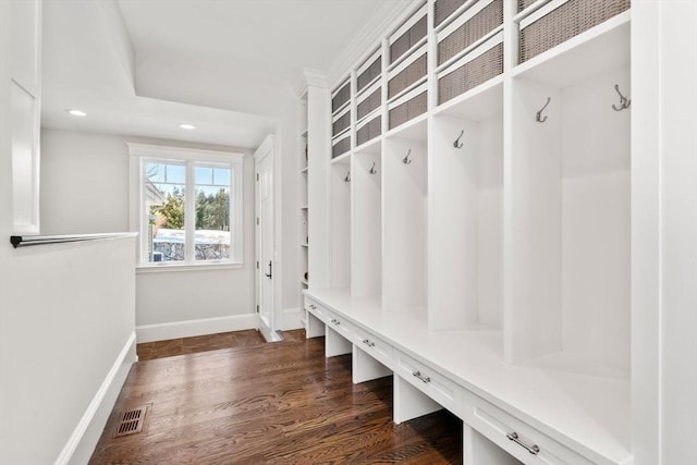 mudroom featuring dark wood-style floors, baseboards, visible vents, and recessed lighting