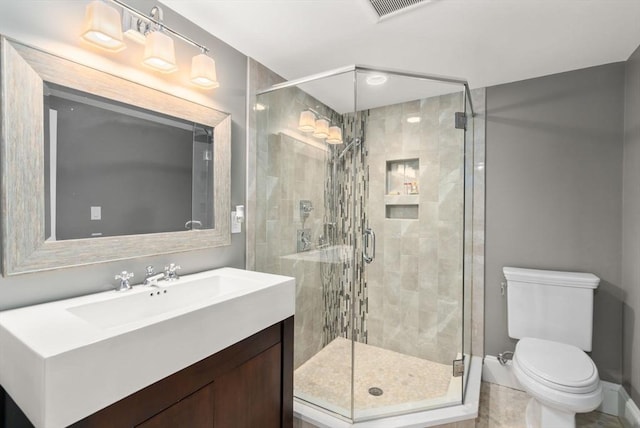 bathroom with visible vents, a stall shower, vanity, and toilet