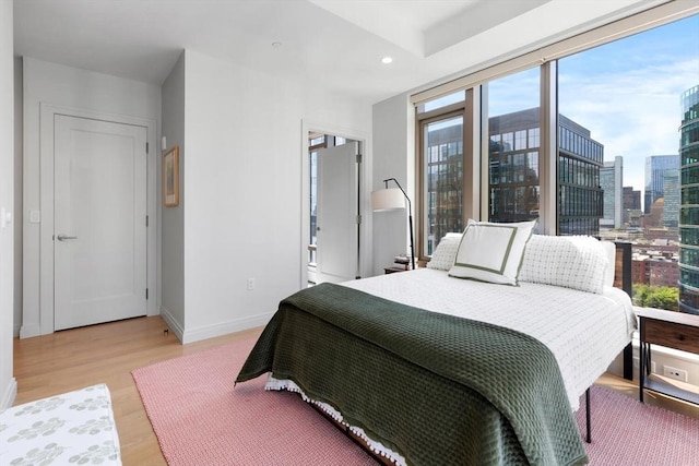 135 Seaport Blvd Unit 1901, Boston, MA 02210 - bedroom featuring light wood-type flooring, recessed lighting, and a view of city