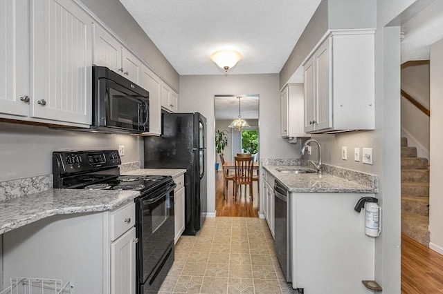 2 Steeplechase Ct Unit 2, Haverhill, MA 01832 - kitchen featuring black appliances, a sink, white cabinetry, and light stone countertops