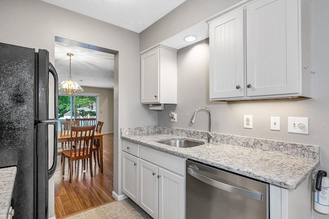 2 Steeplechase Ct Unit 2, Haverhill, MA 01832 - kitchen featuring freestanding refrigerator, stainless steel dishwasher, a sink, a chandelier, and light stone countertops