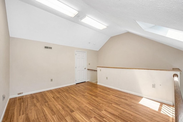 2 Steeplechase Ct Unit 2, Haverhill, MA 01832 - bonus room with light wood-type flooring, vaulted ceiling, a skylight, and baseboards