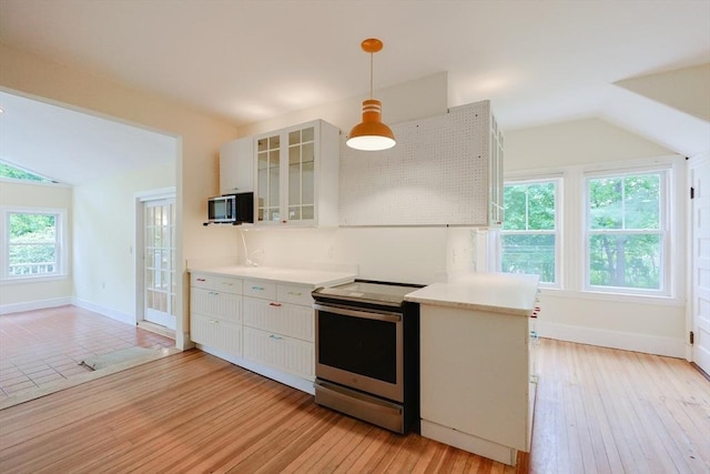 44 Huntington Ave, Sharon, MA 02067 - kitchen with appliances with stainless steel finishes, vaulted ceiling, light countertops, glass insert cabinets, and white cabinetry