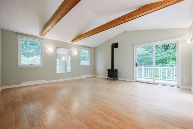 44 Huntington Ave, Sharon, MA 02067 - unfurnished living room featuring a wood stove, light wood finished floors, and baseboards
