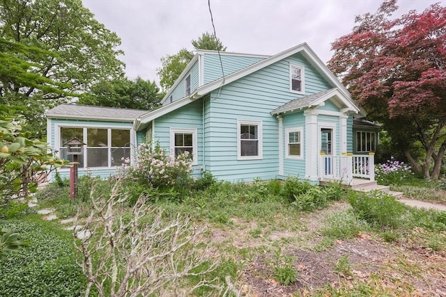 44 Huntington Ave, Sharon, MA 02067 - view of side of property featuring a sunroom and roof with shingles
